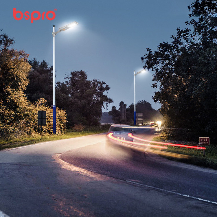 Streetlights illuminating a winding road