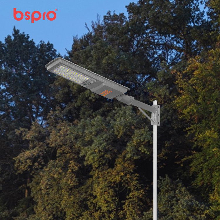 Solar street light against trees